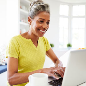 Woman Smiling at Computer