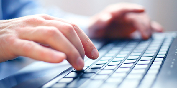 hands typing on keyboard